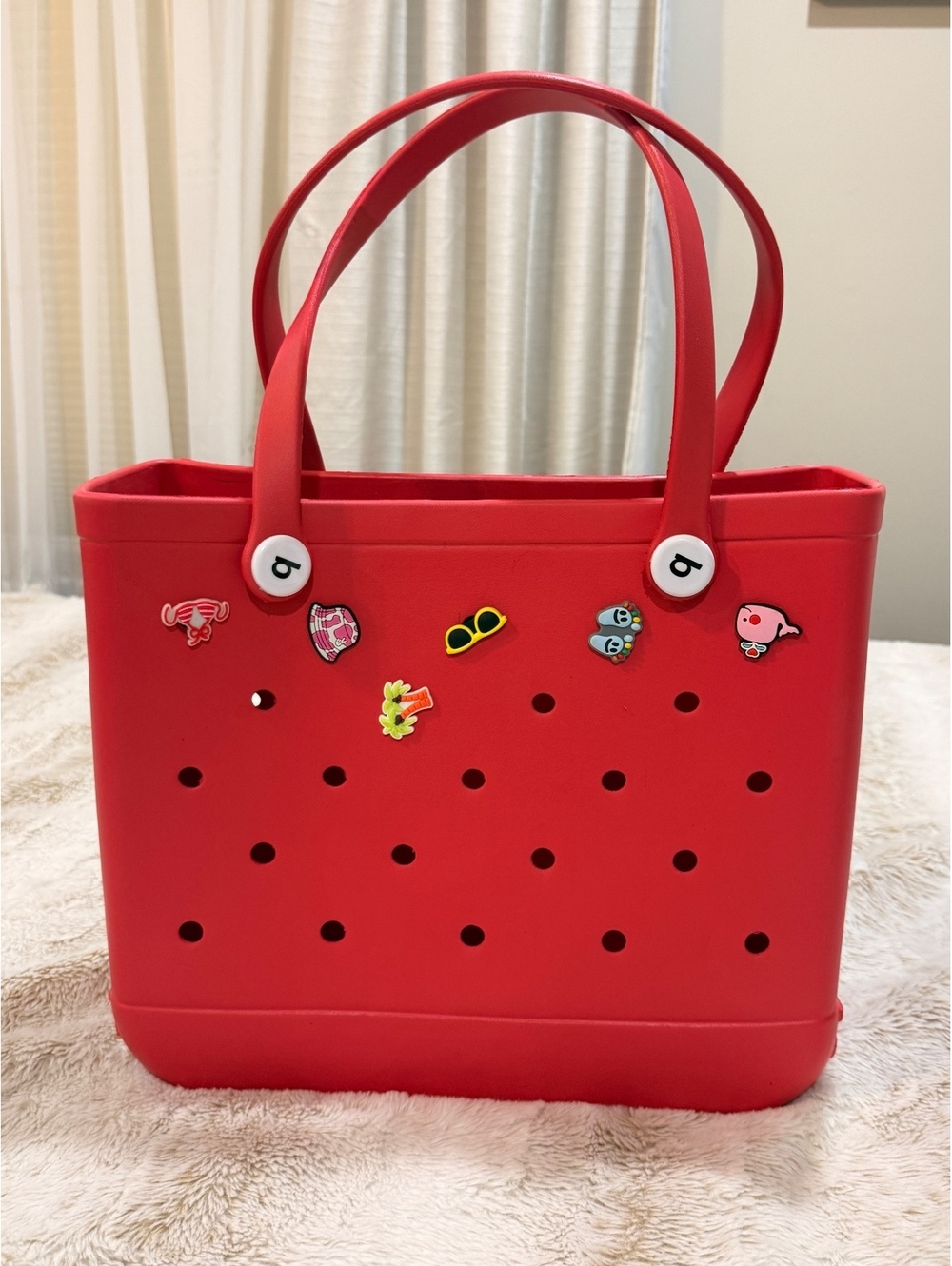 Red perforated tote bag with charms